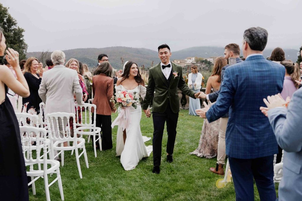 Bride and groom exiting ceremony at their Tenuta di Artimino wedding in Tuscany.