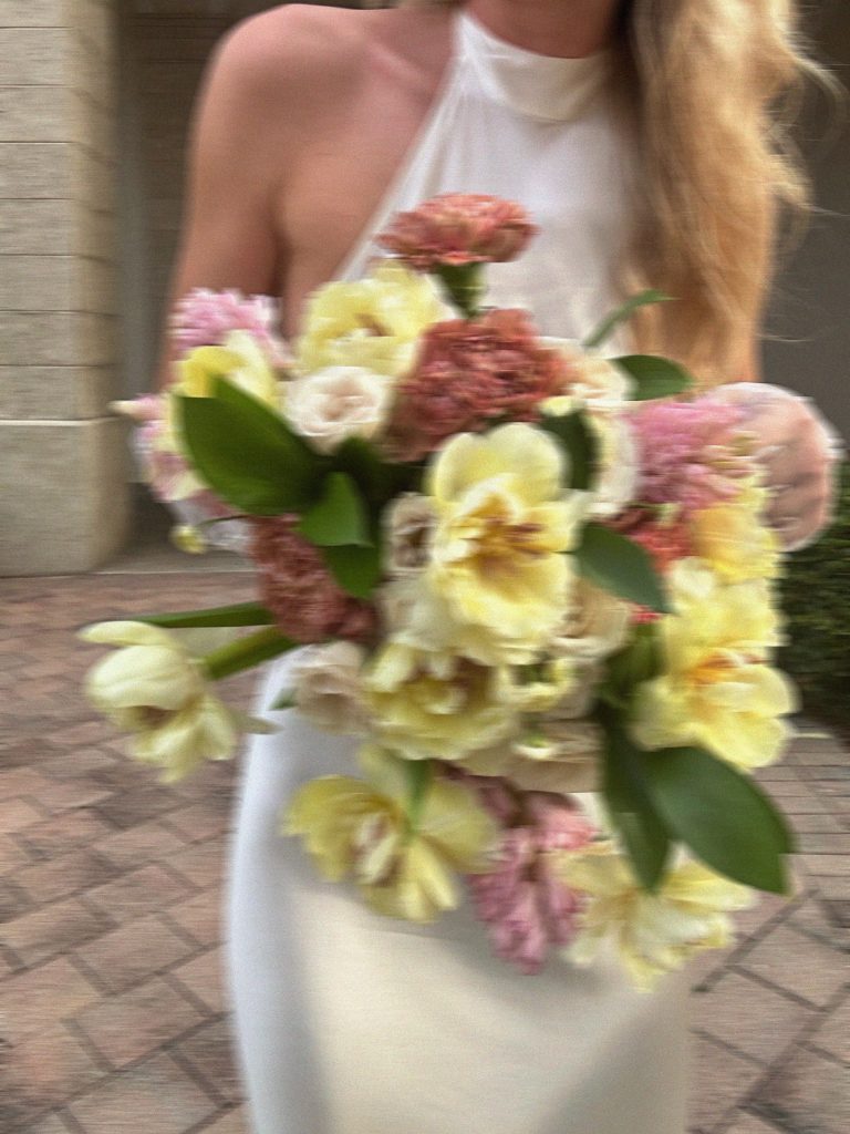 Close up of bride carrying a bridal bouquet.