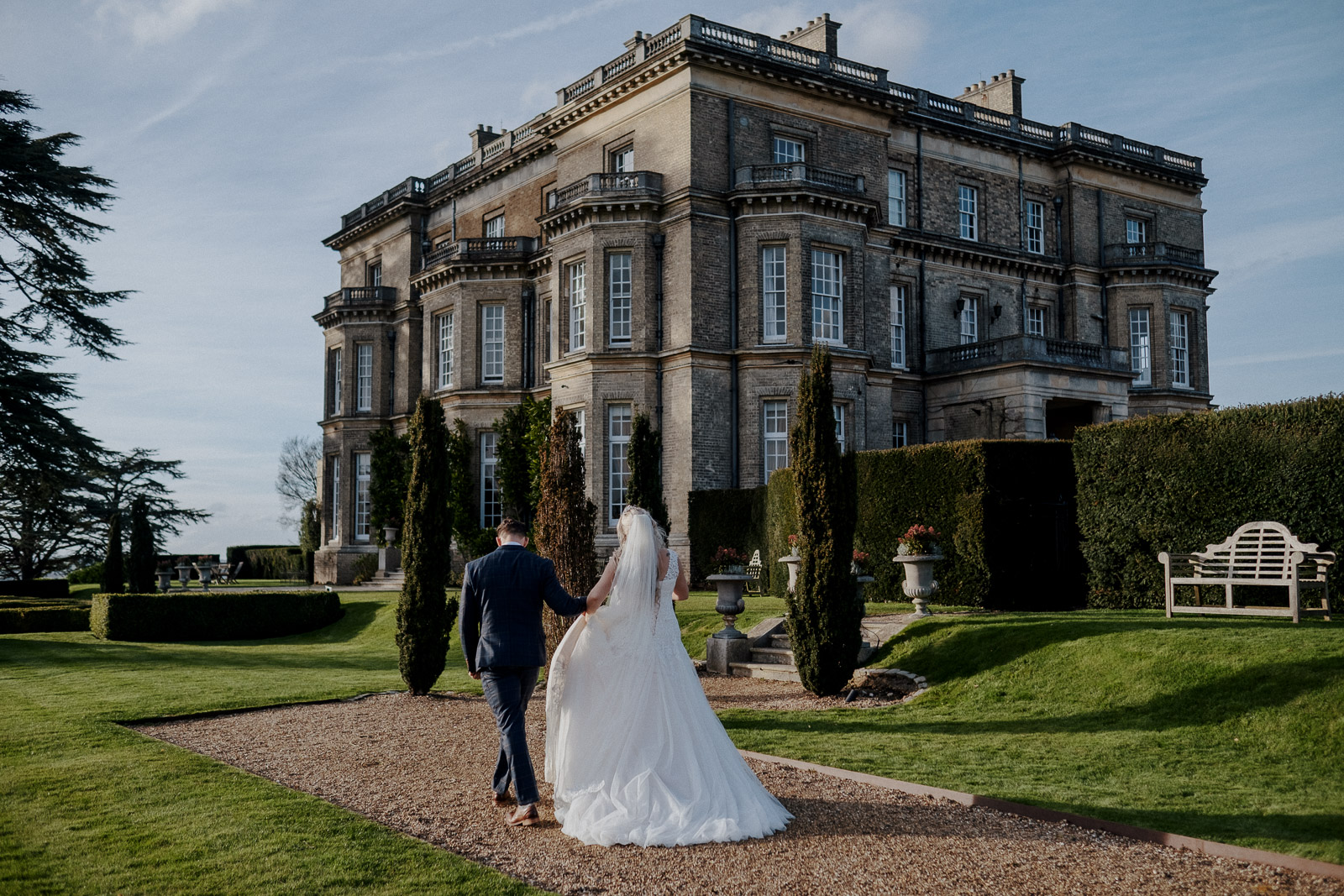 Bride and groom walking in the gardens at their Hedsor House wedding.