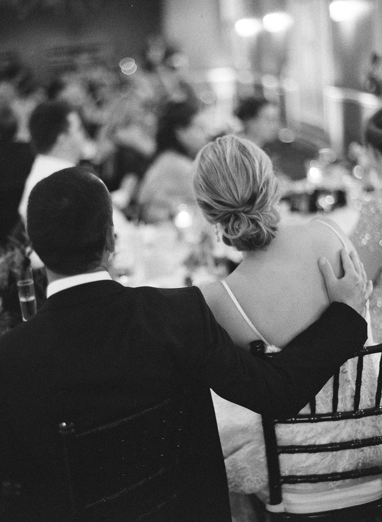 Bride and groom listening to their wedding speeches.